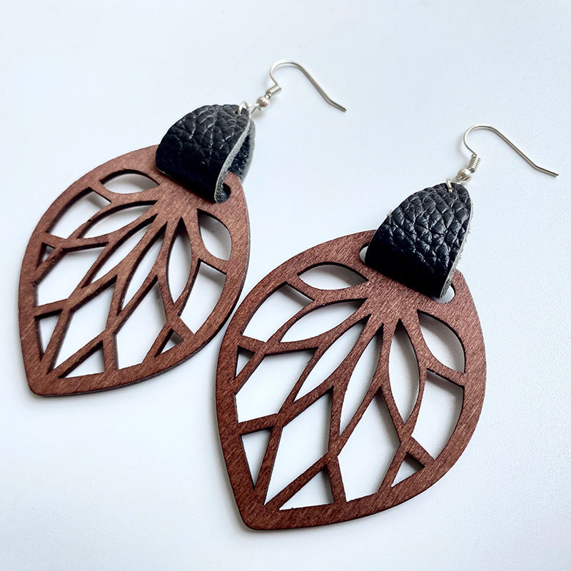 Leaf cutout wood dangle earrings with black leather accent.
