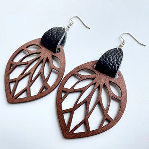 Leaf cutout wood dangle earrings with black leather accent.