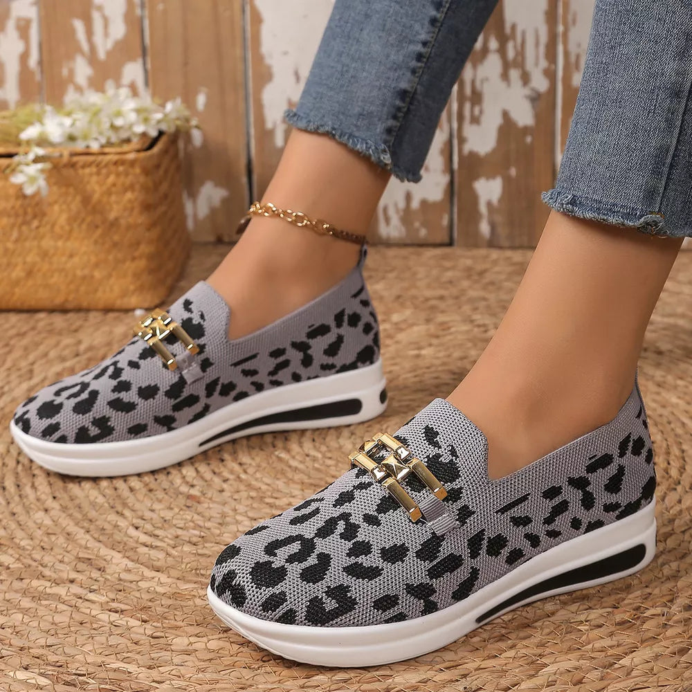 Gray leopard print mesh slip-on shoes with gold buckle detail and white sole.