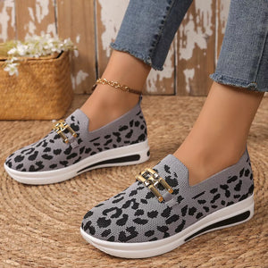 Gray leopard print mesh slip-on shoes with gold buckle detail and white sole.