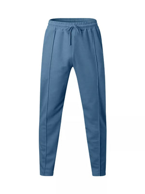 Casual drawstring sweatpants in denim blue with pockets and front seam detail.