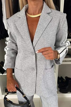 Light gray casual blazer with white track stripes on sleeves, buttoned front, and pocket details.
