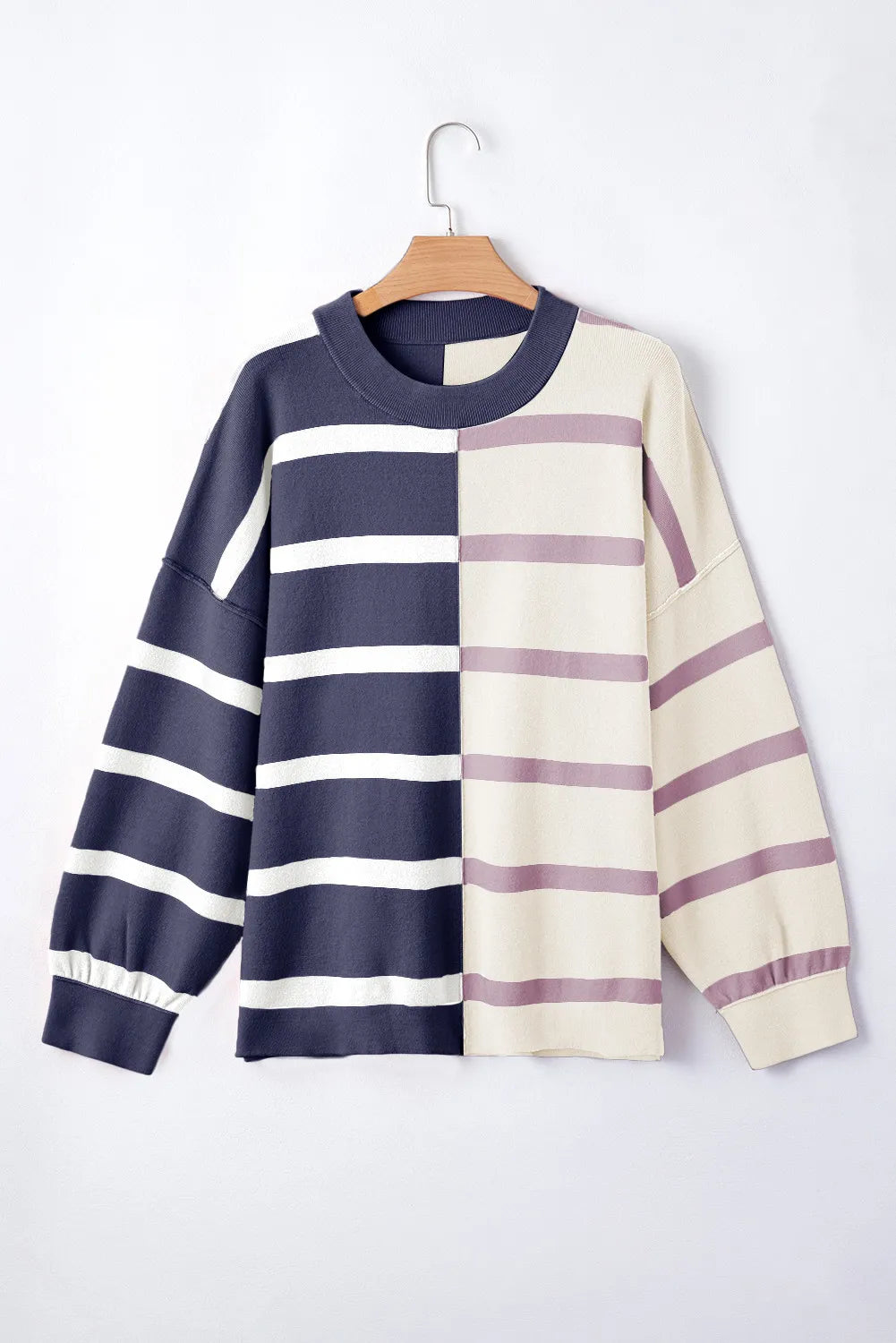 Colorblock stripe knit pullover with navy and cream panels and crew neck.
