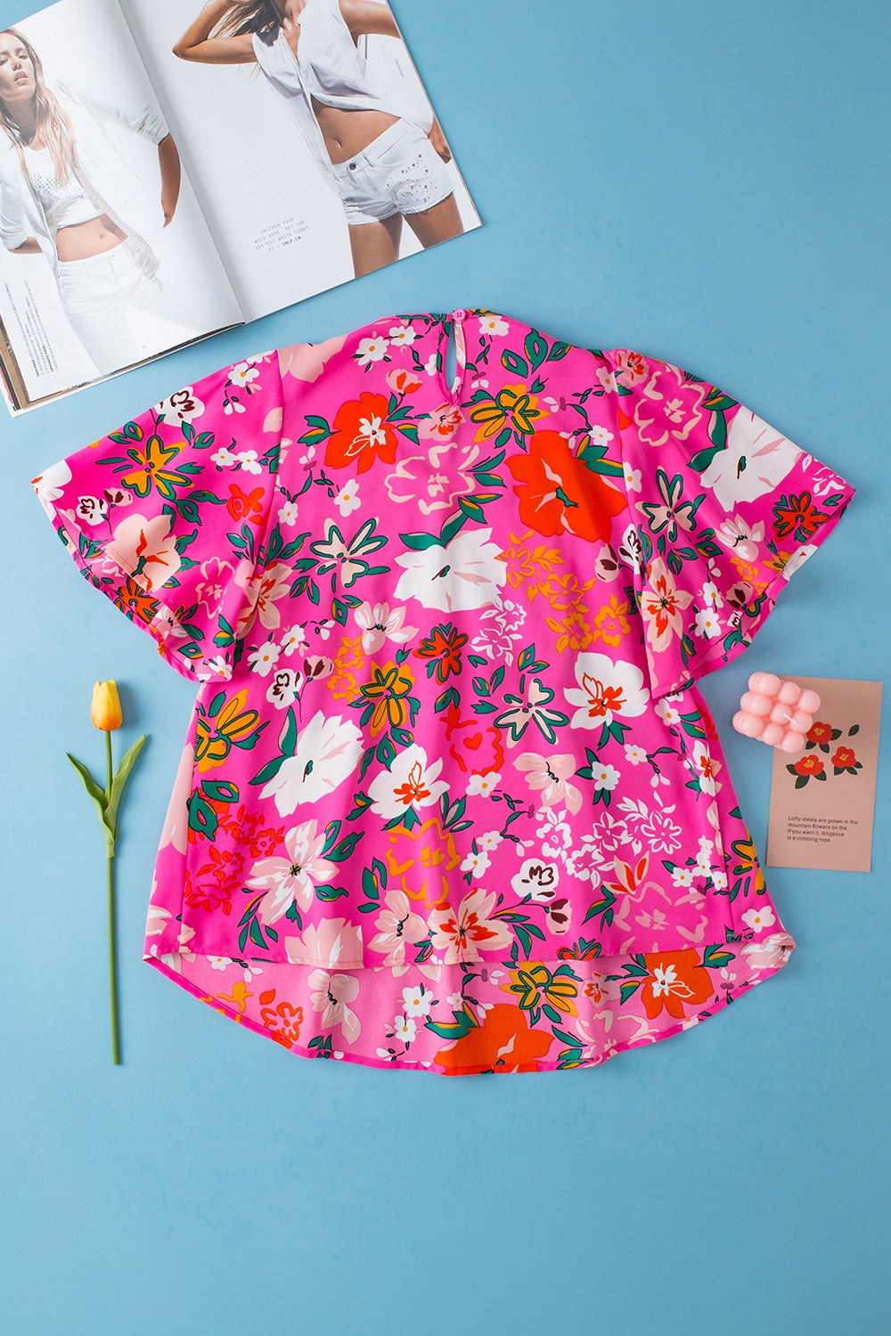 Hot pink floral blouse with flutter sleeves and smocked yoke detail