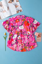 Hot pink floral blouse with flutter sleeves and smocked yoke detail