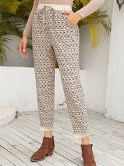 Geometric print drawstring trousers with cuffed hems and pockets.