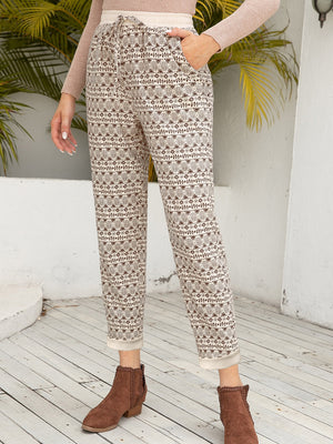 Geometric print drawstring trousers with cuffed hems and pockets.