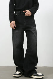 Faded black denim palazzo jeans with a relaxed, oversized fit.