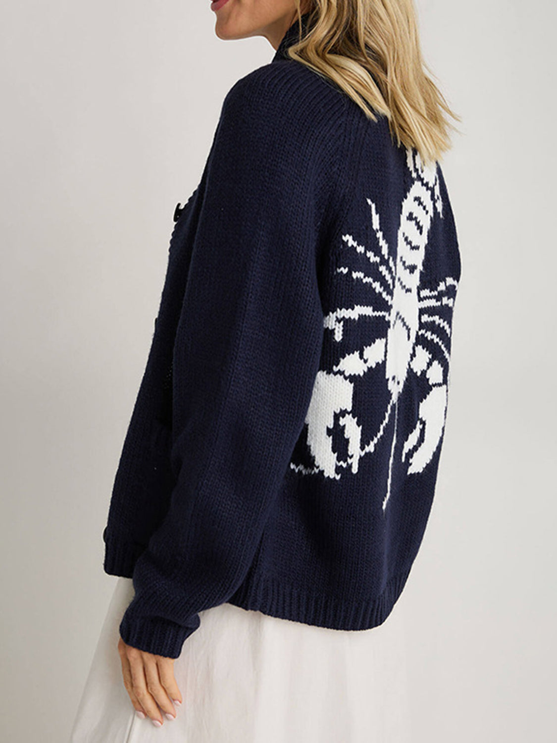 Dark blue acrylic knit cardigan with white lobster appliqué on back, buttoned front.