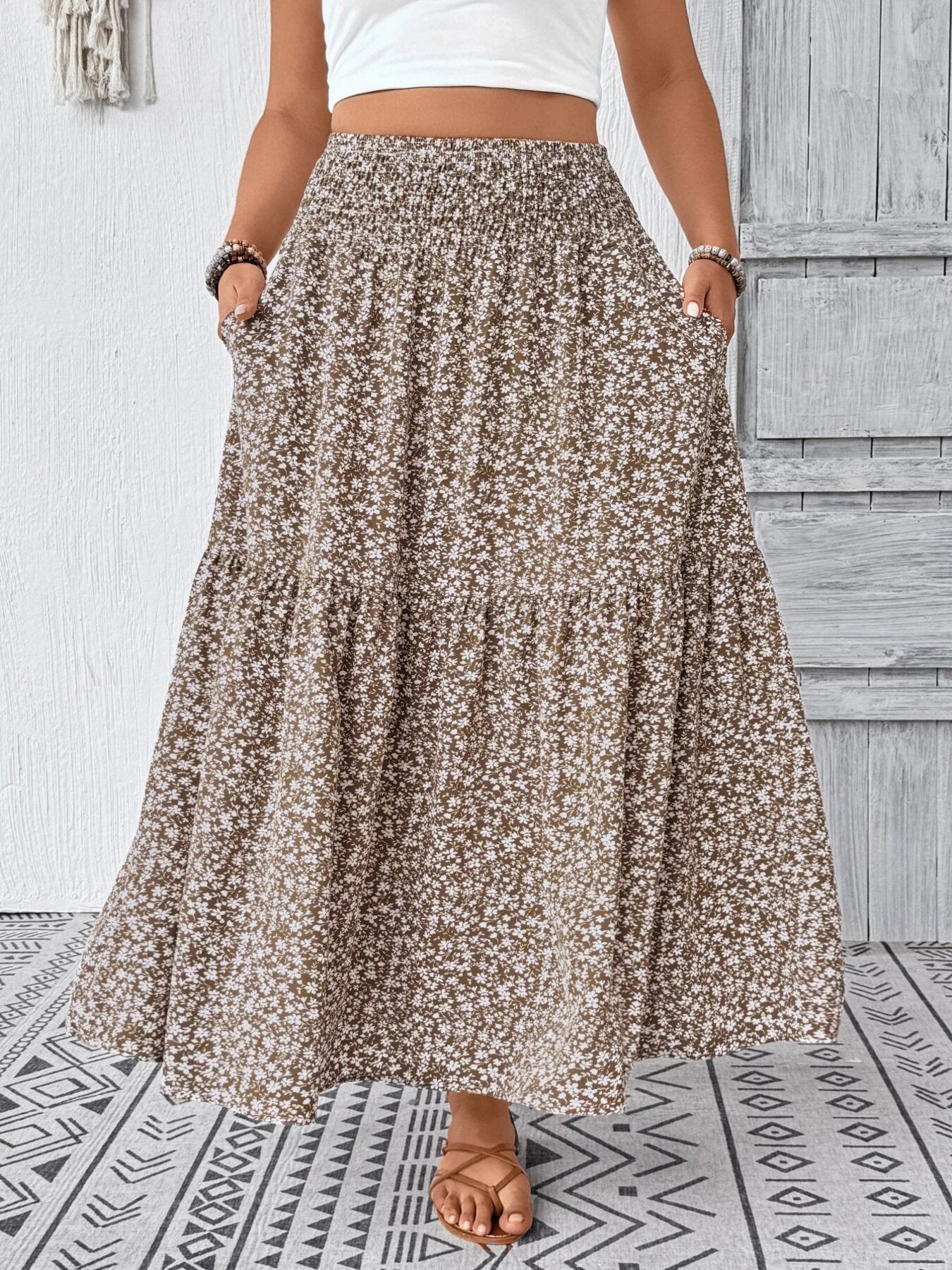 Tiered maxi skirt in mocha with a white floral print and pockets.