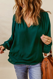 Green ruched cuff voluminous sleeve blouse with V-neckline.