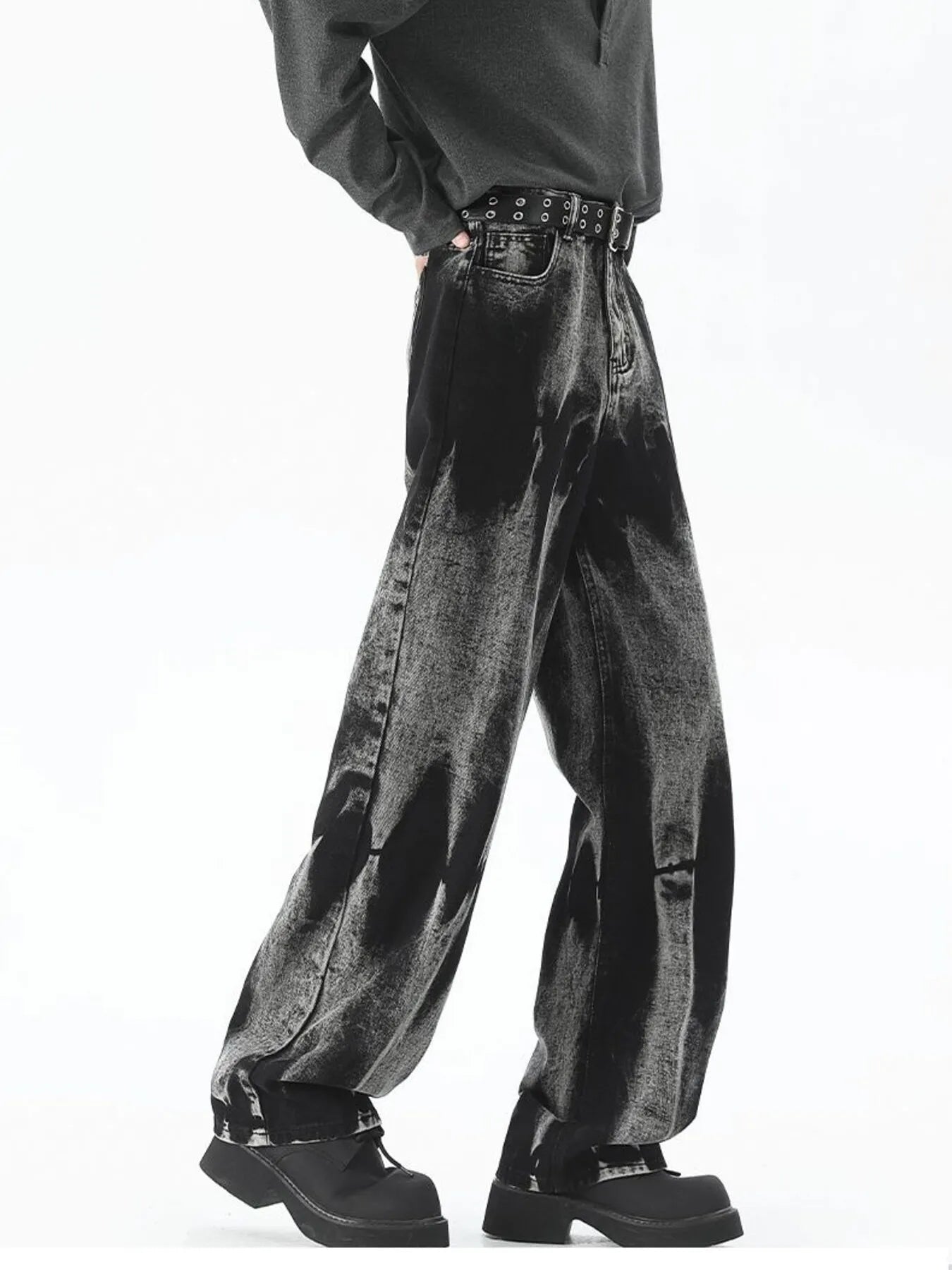 Men's black relaxed fit jeans with acid wash detail and studded belt.
