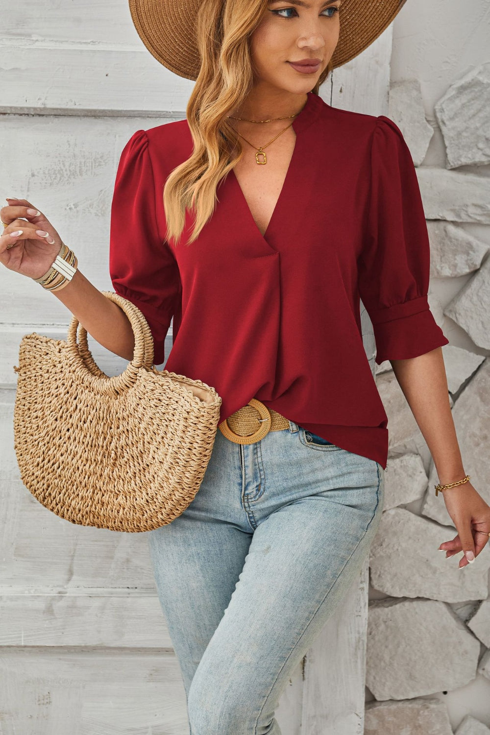 Burgundy blouse with puffed sleeves and flared cuffs, V-neckline.