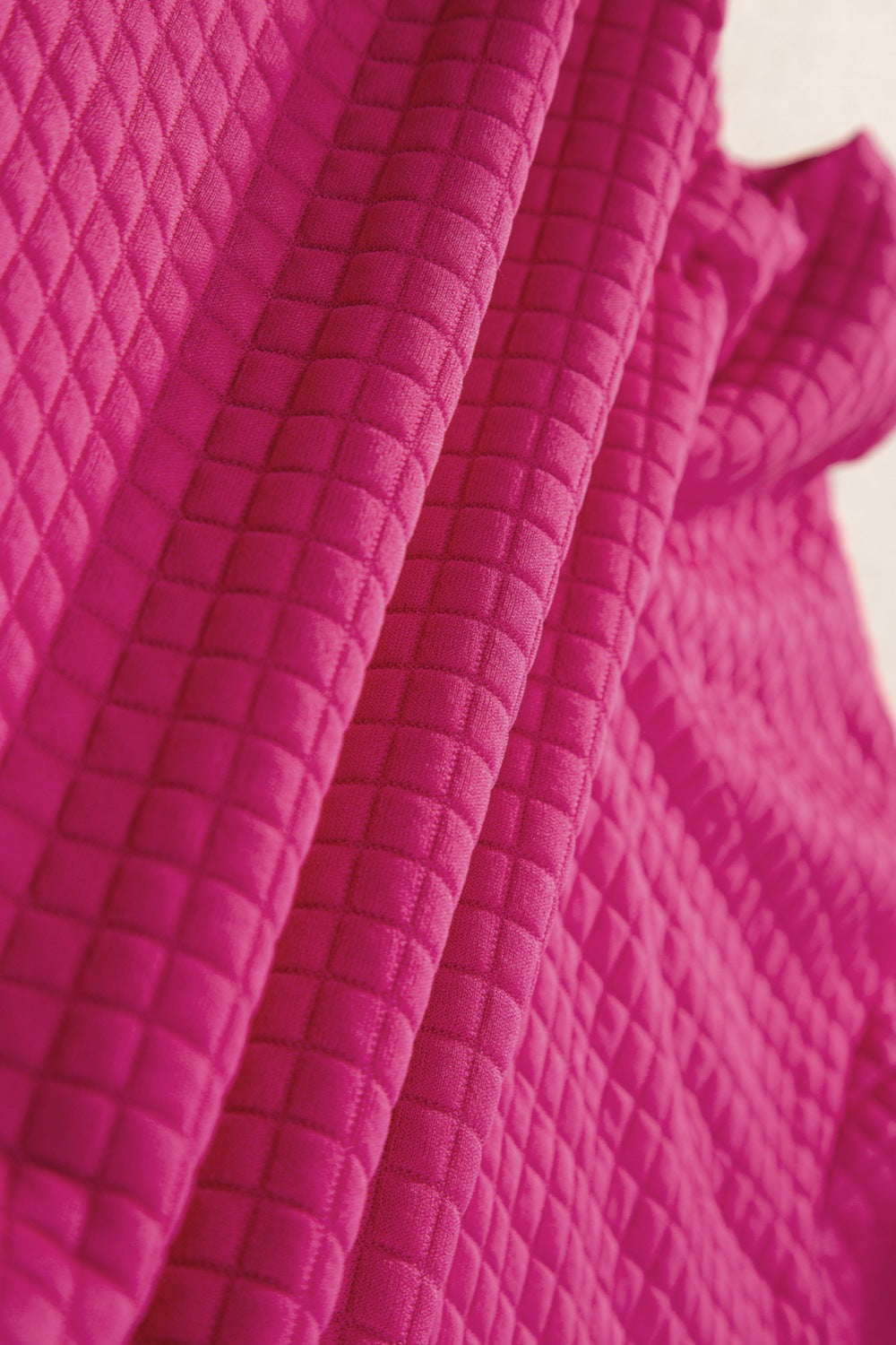 Hot Pink quilted knit fabric with diamond pattern detail.