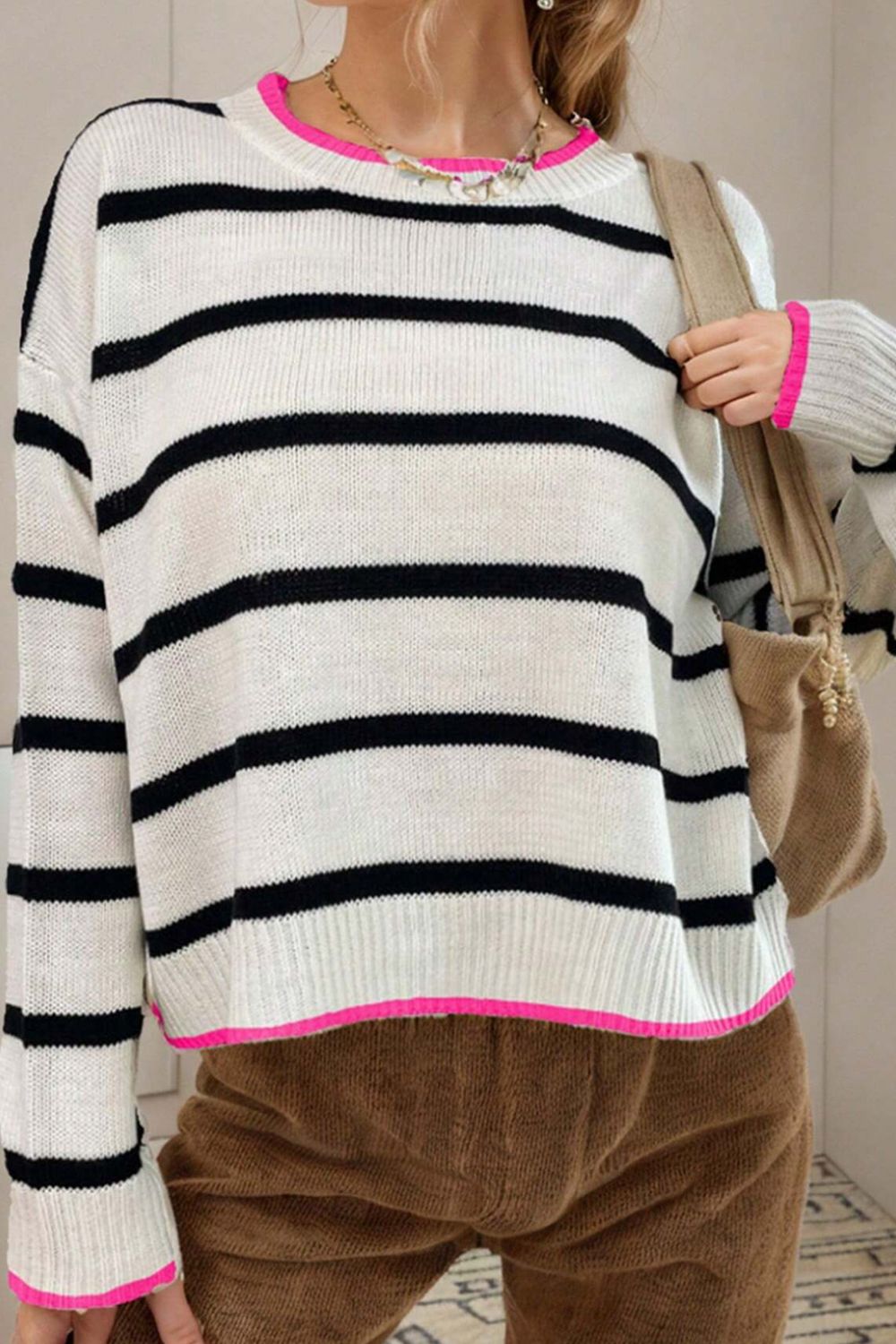 Stripe knit sweater with contrast pink trim and crew neck.