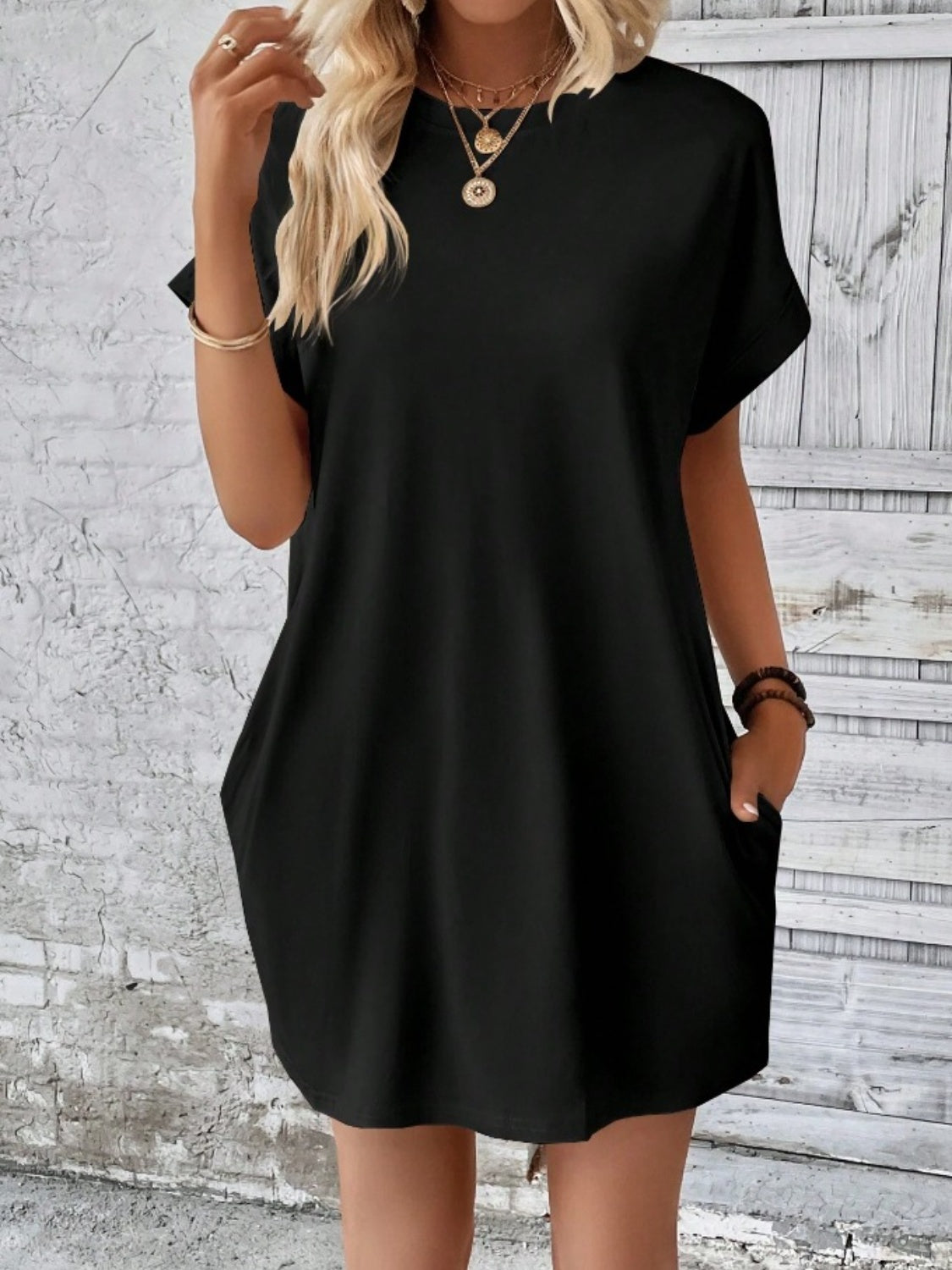Black relaxed tee dress with cuffed sleeves and pockets