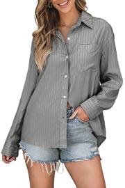 Oversized gray stripe button-up shirt with a pocket, worn casually with denim shorts.