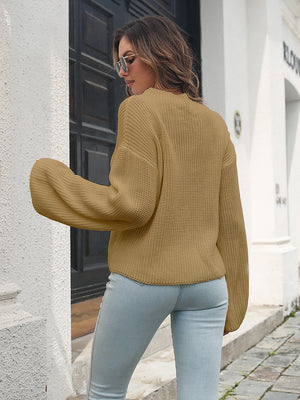Camel batwing sleeve knit pullover sweater with ribbed texture.