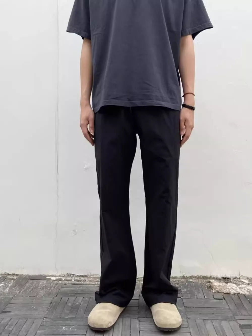 Men's black sweatpants with a relaxed fit and drawstring waist.