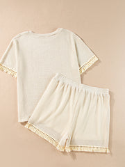 Cream waffle knit outfit set with fringe trim on short sleeves and hem.