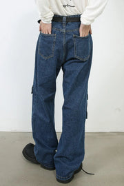 Medium wash denim cargo pants with buckle pocket detail and wide leg cut.
