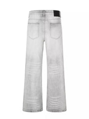 Men's gray vintage wash wide leg jeans with distressed details.