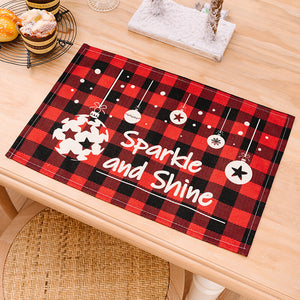 Festive plaid placemat with Christmas ornaments and "Sparkle and Shine" text.