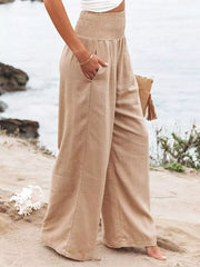 Tan smocked wide-leg maternity pants with pockets, styled casually.