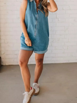 Denim romper with zipper closure, cuffed shorts, and collared neckline.