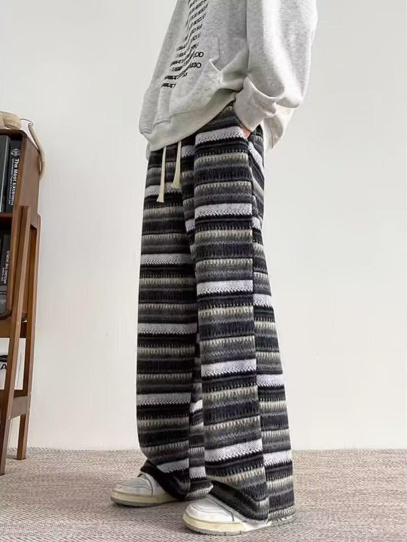 Men's wide-leg pants with a horizontal striped pattern and drawstring waist.