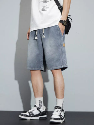 Men's light blue denim shorts with drawstring waist and loose fit.