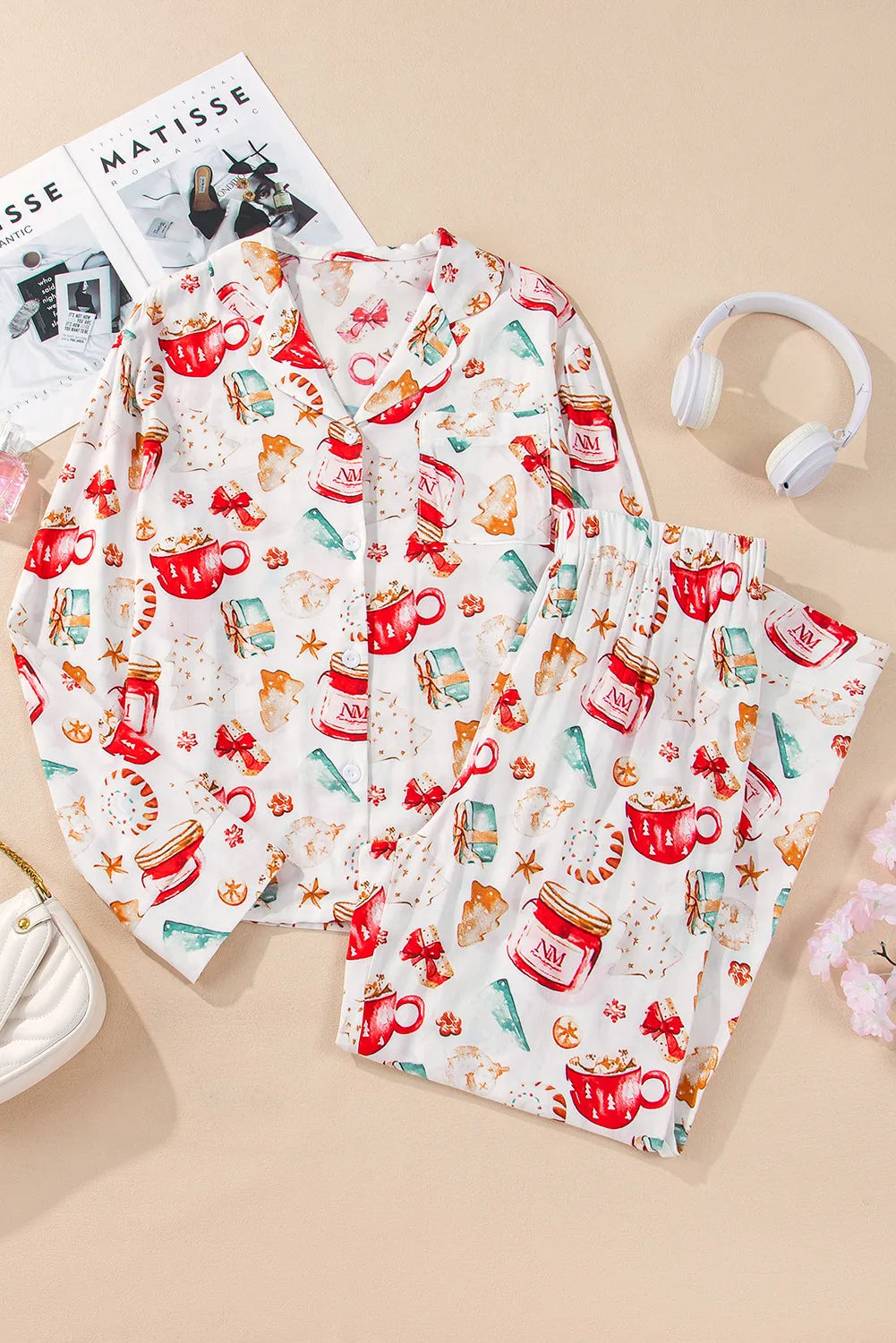 White collared pajama set with festive holiday print of mugs, gifts, and cookies.