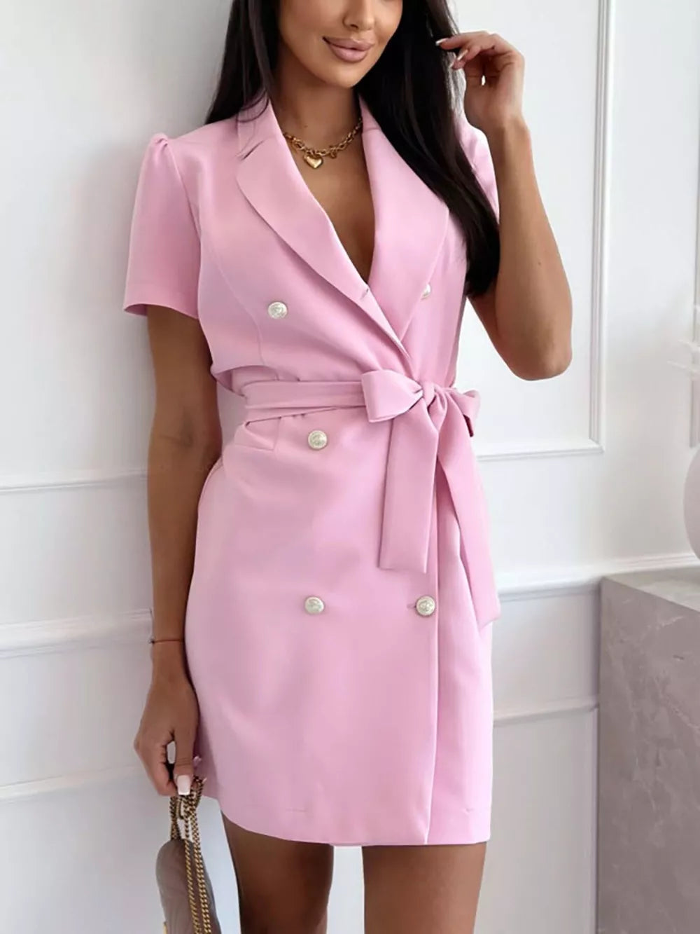 Blush pink double-breasted blazer dress with short sleeves, chic belt, and pearl buttons.