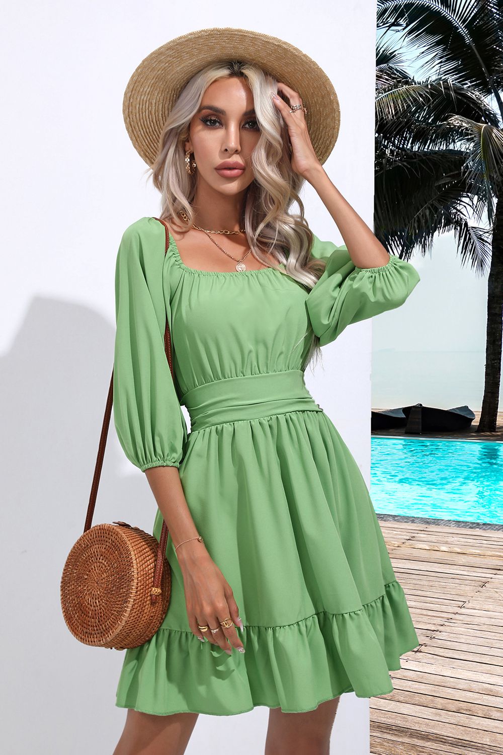 Light green mini dress with square neck, bow-tie sleeves, and tiered ruffle hem.