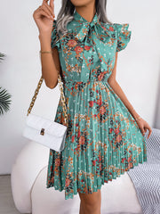 Turquoise floral mini dress with ruffle sleeves, bow neckline, and pleated A-line skirt.