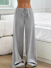 Light gray ribbed wide-leg pants with drawstring waist and a relaxed fit.