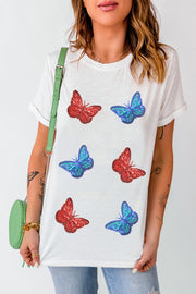 White t-shirt with embroidered red and blue butterfly motifs