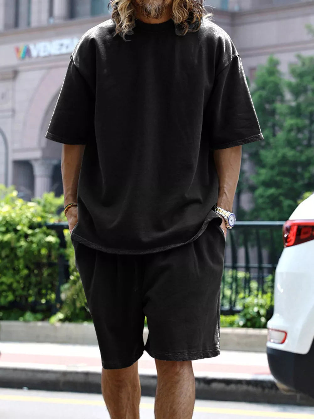 Men's black relaxed fit two-piece set with drawstring shorts and short sleeve tee.