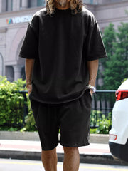 Men's black relaxed fit two-piece set with drawstring shorts and short sleeve tee.