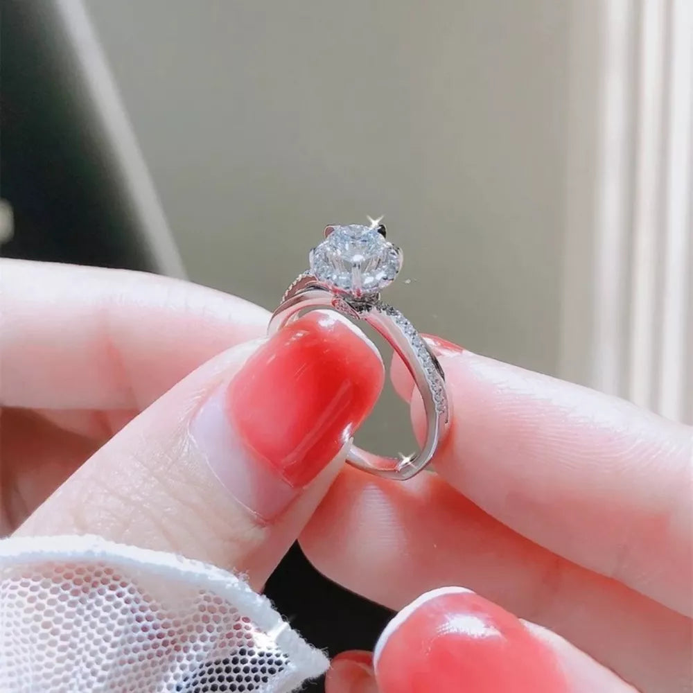 Brilliant moissanite ring in sterling silver with pave band detail.