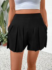 Black pleated shorts with pockets and a textured fabric.
