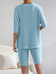 Light blue ribbed loungewear set with V-neck top and bike shorts.