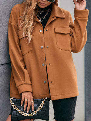 Oversized caramel utility jacket with snap closure and chest pockets.