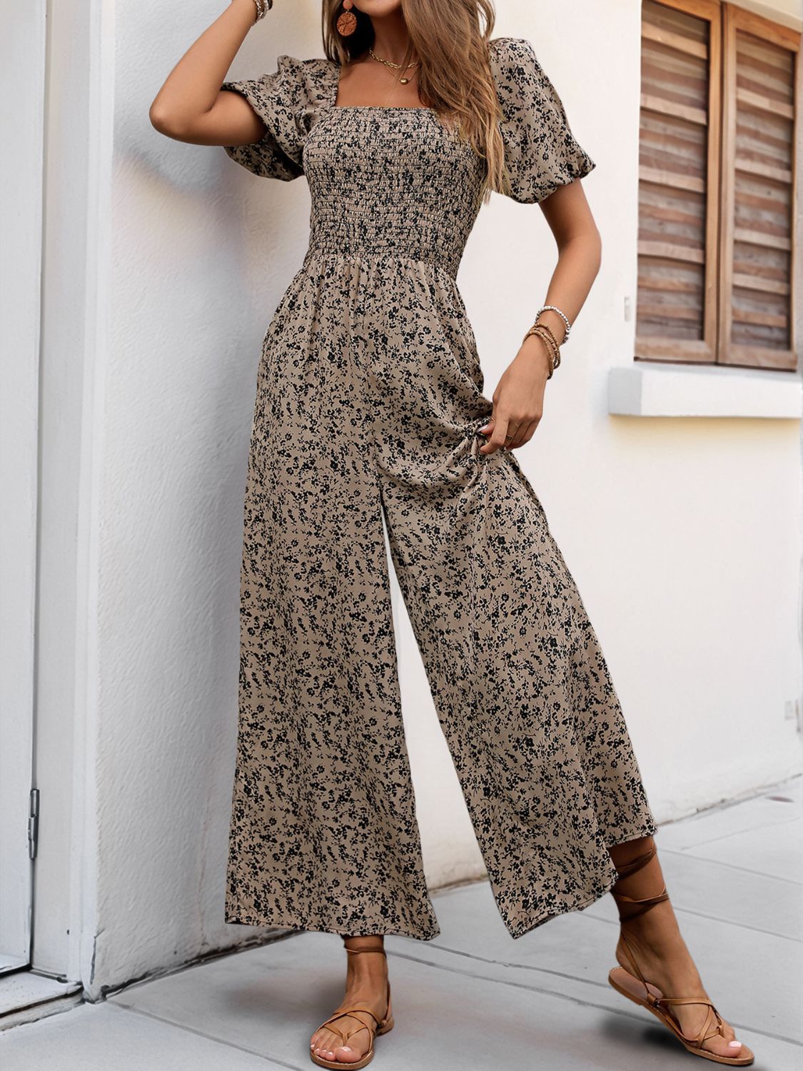 Smocked bodice floral palazzo jumpsuit in taupe with puff sleeves and square neckline.