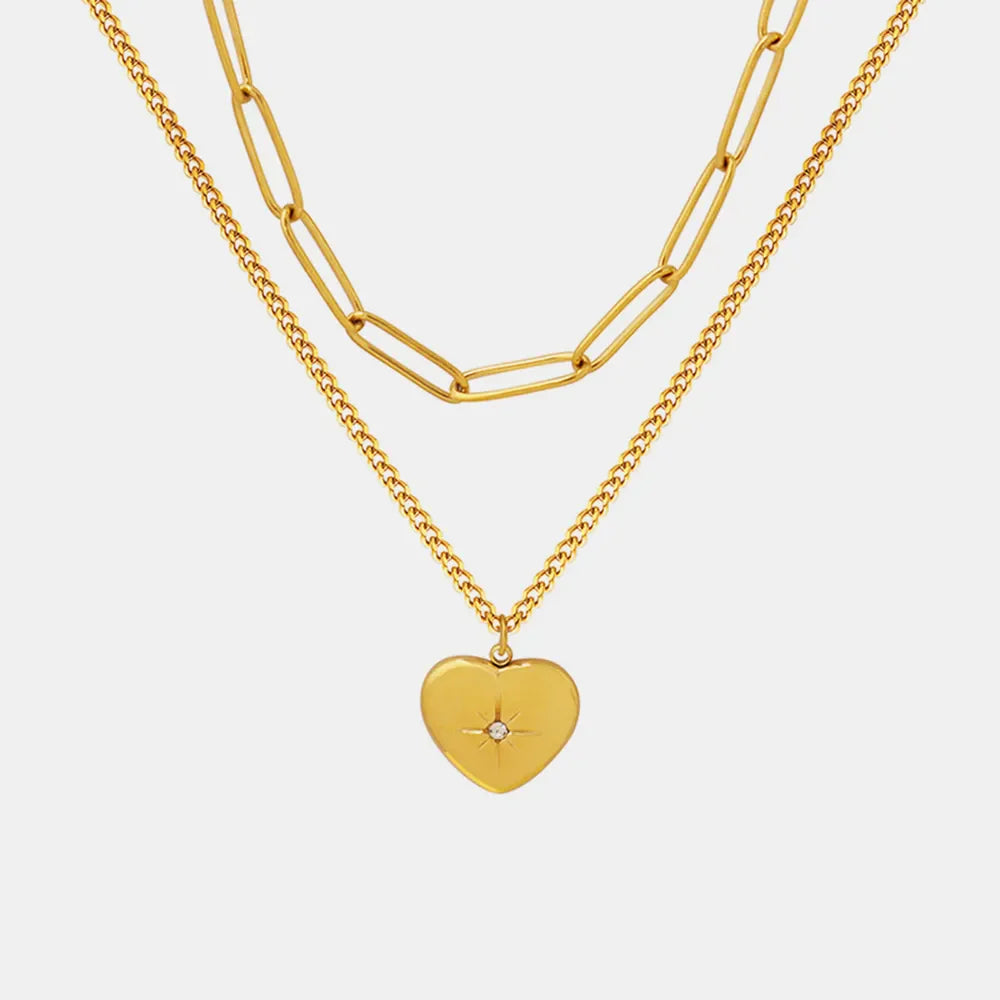 Gold layered necklace with paperclip chain and heart pendant with crystal detail
