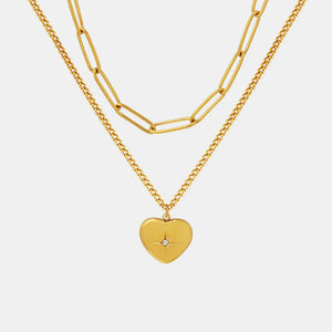Gold layered necklace with paperclip chain and heart pendant with crystal detail