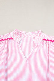 Blush pink and white striped blouse with ruffled neckline and scalloped trim detail.