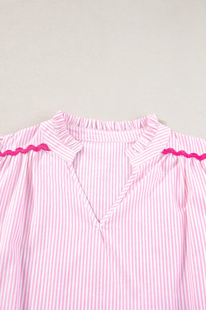 Blush pink and white striped blouse with ruffled neckline and scalloped trim detail.