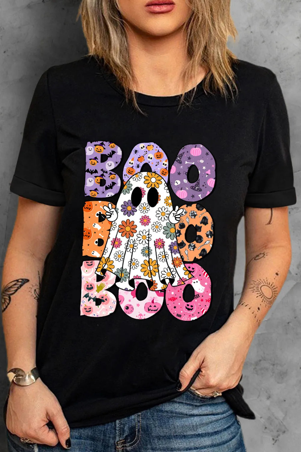 Black t-shirt with floral ghost and colorful "Boo" Halloween graphic.