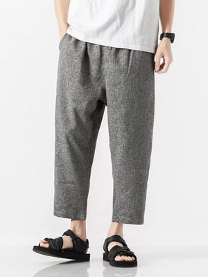 Men's light gray relaxed fit cropped sweatpants with drawstring waist and pockets.